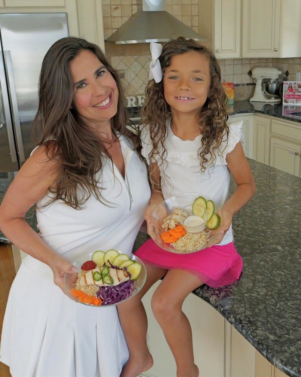 Devin Alexander and her daughter Cayenne holding matching meals